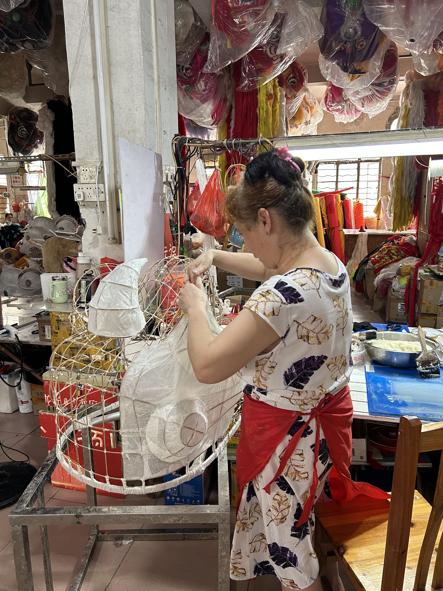 Artisan constructs the head of a Chinese dancing lion