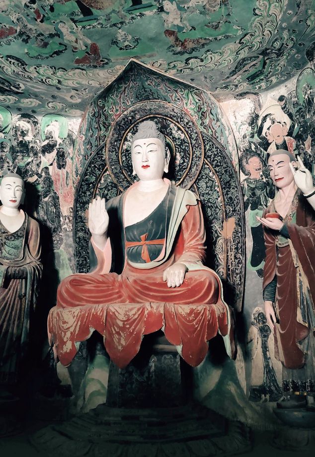 A Buddhist statue carving on the cliff of Mogao Caves in Gansu province