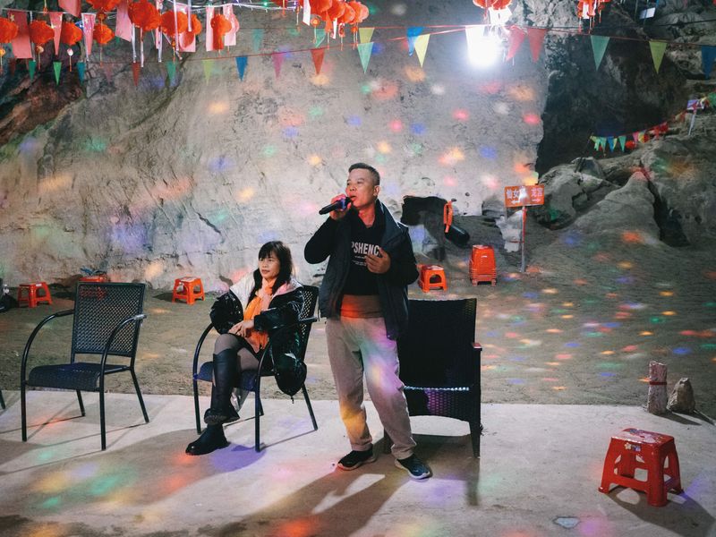 A man singing a love song in a cave near Liuzhou, Guangxi