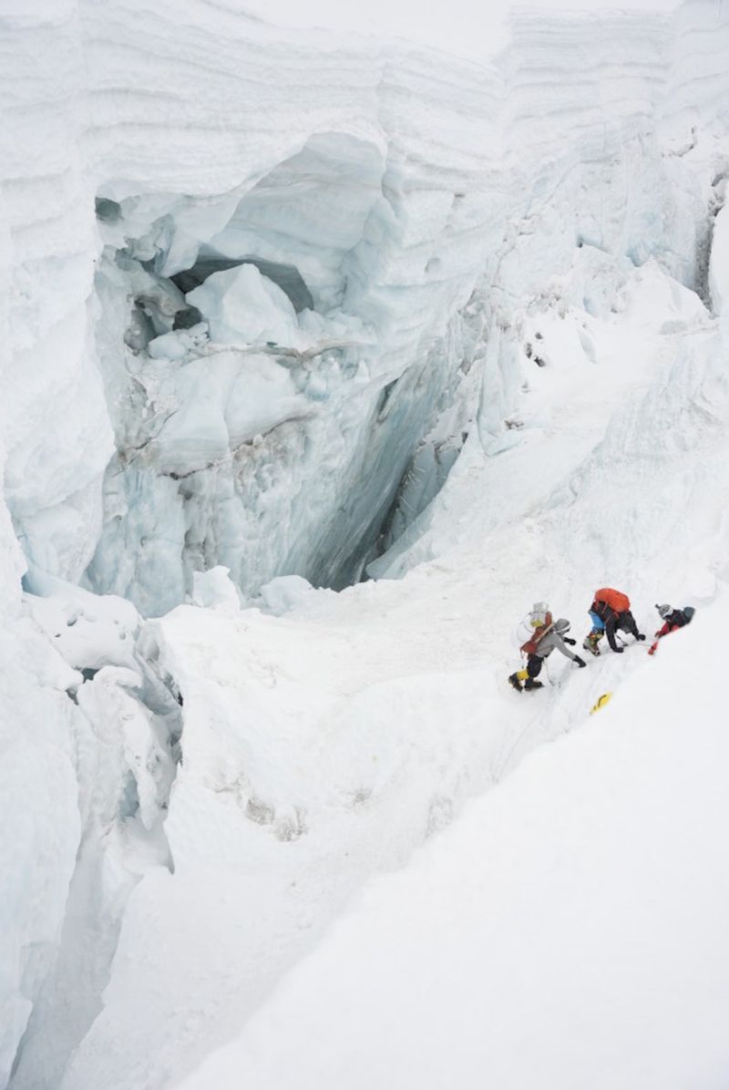 Three hikers preparing to scale Mount Everest