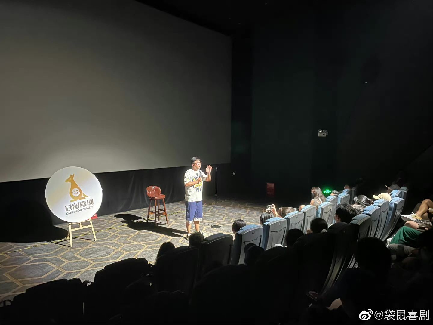 Audience listening to a comedian performing at a Kangaroo Comedy performance