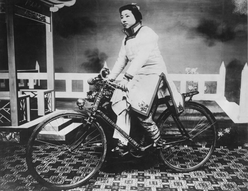 A Chinese woman in the 1910s posing for a photo on a bicycle. After the Revolution of 1911, women gained a more active role in society. (VCG)