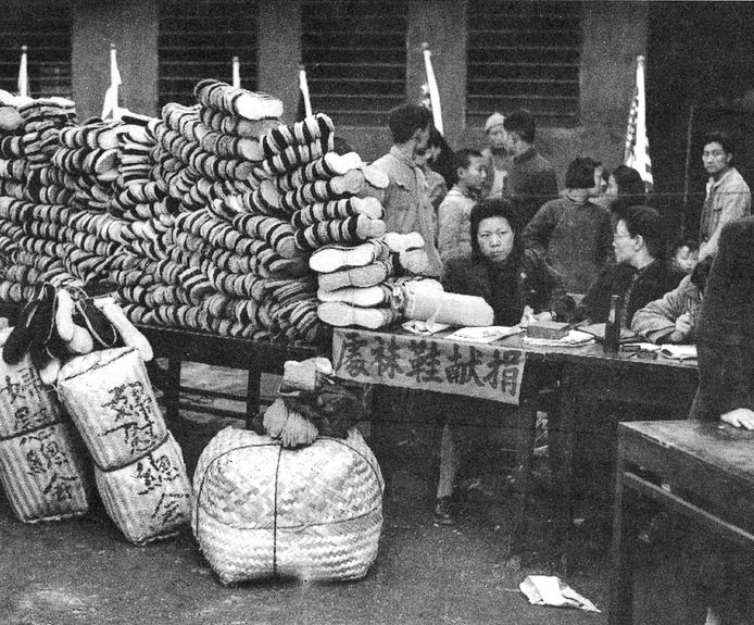 A member of the Women’s Federation, a forerunner to the ACWF, taking donations of clothes, shoes, and socks for civilians and soldiers wounded during war with Japan, in Chongqing on March 8